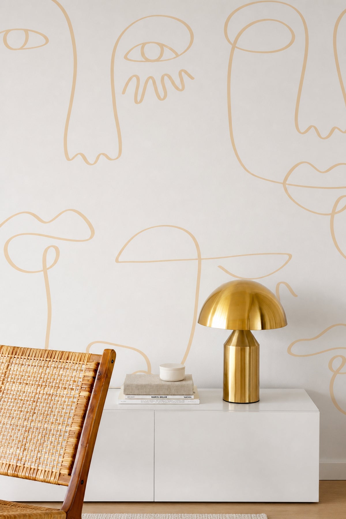 White Gold Minimal Abstract Faces mural styled with rattan chair and brass lamp