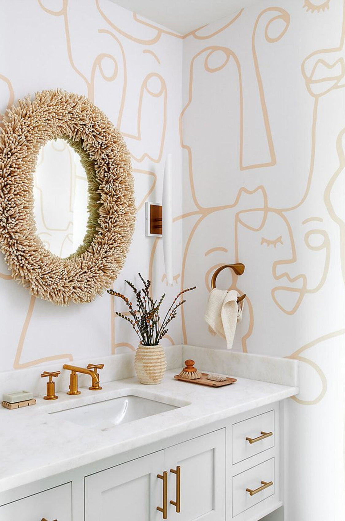 abstract gold faces in chic powder room