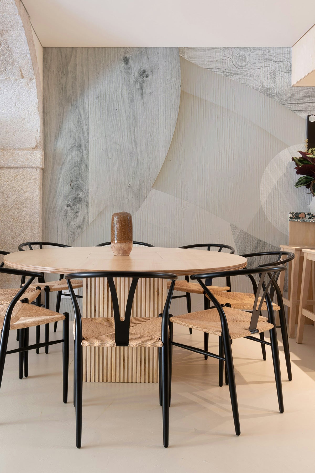 Astra Veil / Wood Wall Mural in a dining area with a round table and chairs.
