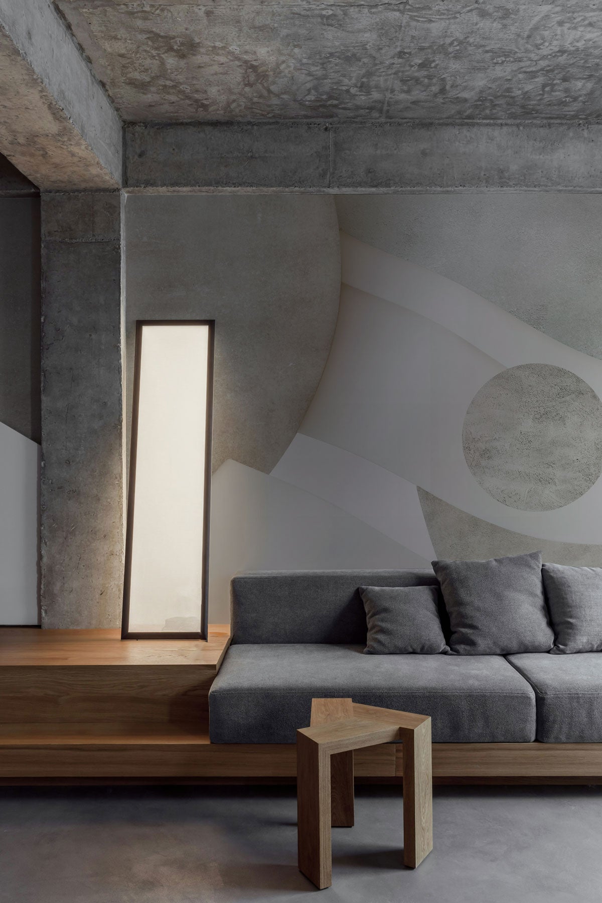 Astra Veil Stone in a modern living room with gray sofa and wooden table.