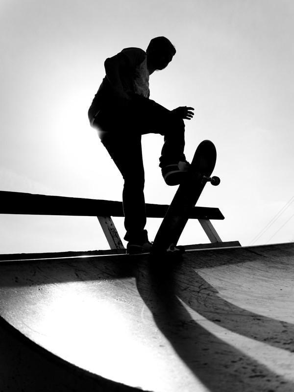 Silhouette of a young skateboarder Wall Mural-Wall Mural-Eazywallz